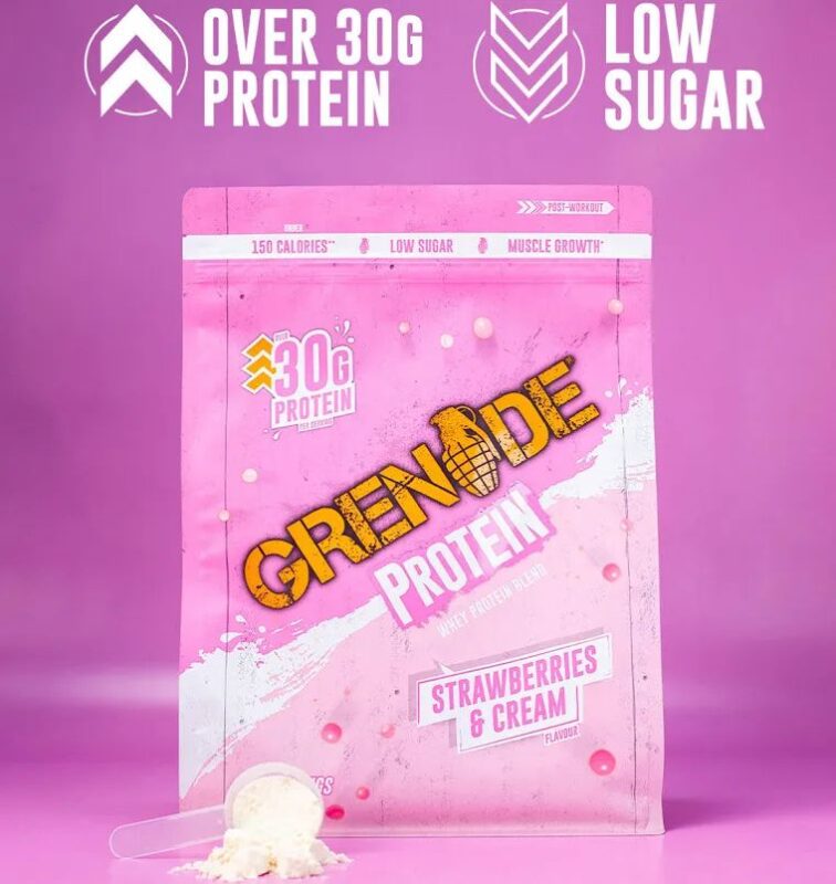 Grenade Protein Strawberries & Cream whey protein pouch with 30g protein displayed on a pink background with a scoop of protein powder.